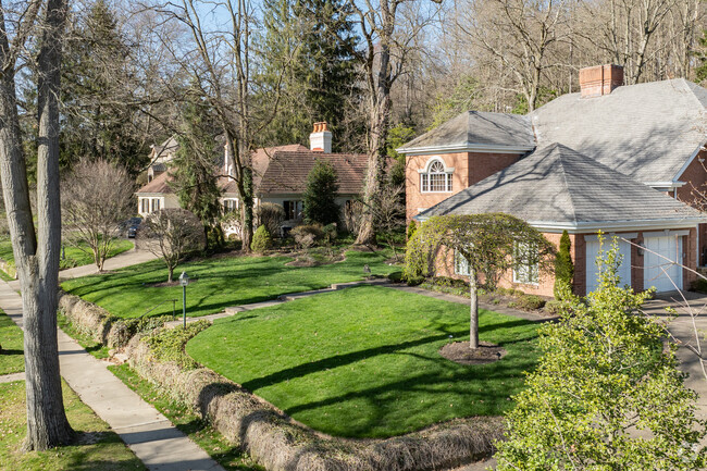 Some large homes in Edgeworth have sidewalks and lawns out front.