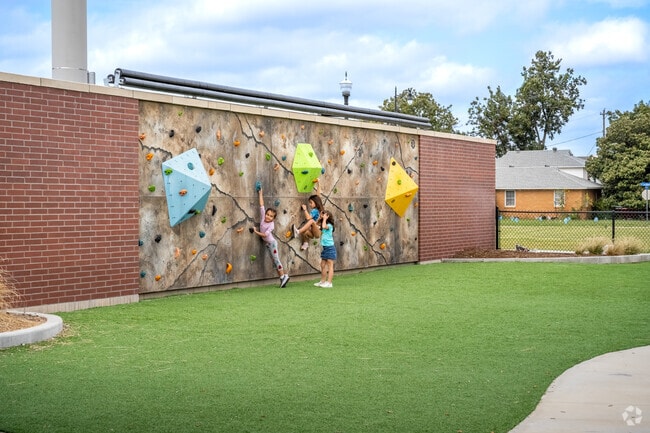 Midwest City children can play at the climbing wall at a neighborhood park.