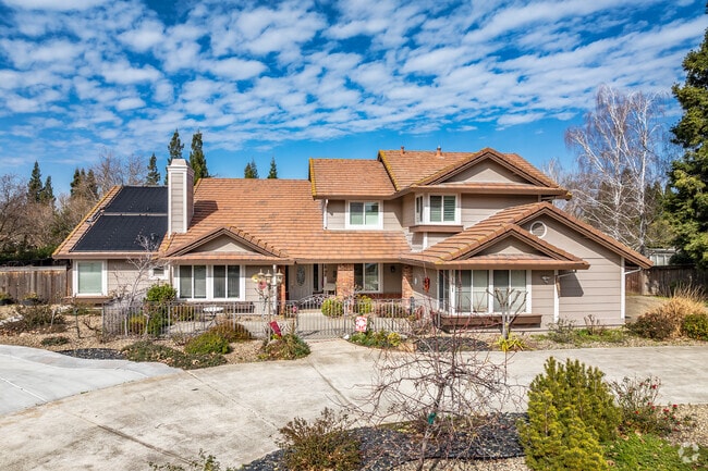 This Contemporary Mediterranean home has a tile roof and a brick entryway in Vineyard.