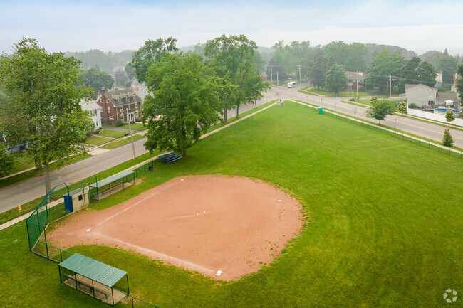 Maple Avenue Elementary School has a baseball diamond right next to the building.