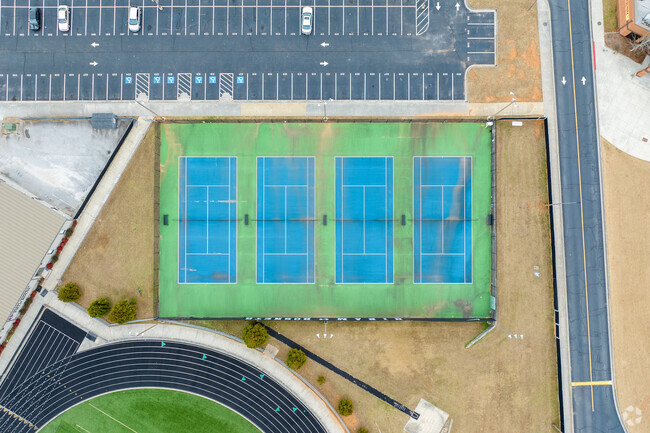 Hiram High School's campus features multiple sports areas, like tennis courts.