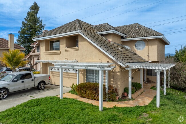 Mediterranean revival homes in Watsonville showcase stucco exteriors and tiled roofs.