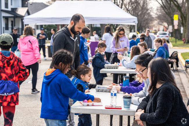 Kids turn in eggs for a goodie bag at the Egg-cellent News Easter Egg Hunt.