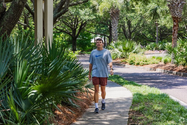 Seaside residents enjoy a nice walk under the canopy of trees in Mount Pleasant.