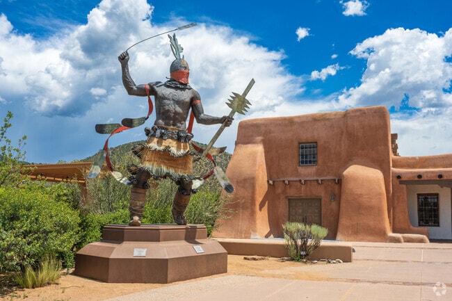 The powerful Apache Mountain Spirit Dancer towers over Milner Plaza on top of Museum Hill.
