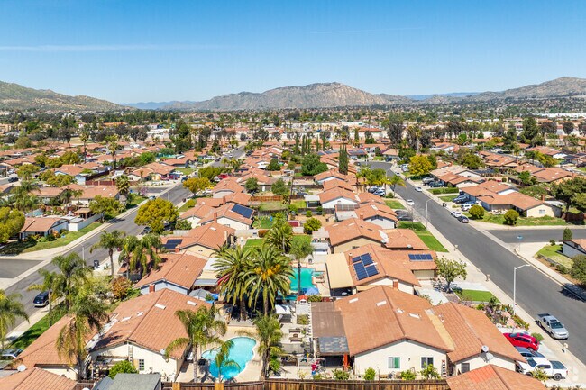 Sunnymead streets are gridded and lined with sidewalks, and houses have fenced-in yards.