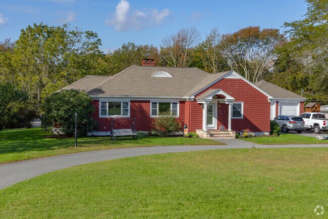 A curvilinear portico serves as a formal entry to this ranch in the Eagleville neighborhood.