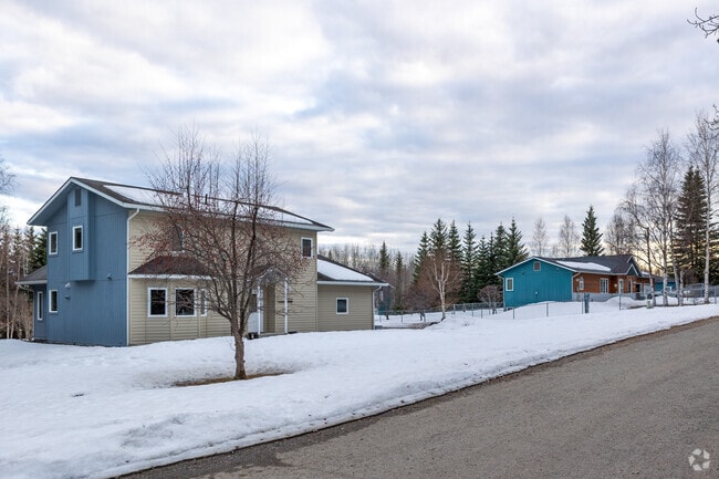 Snowy streets frame cozy two-story homes in the quiet College neighborhood.