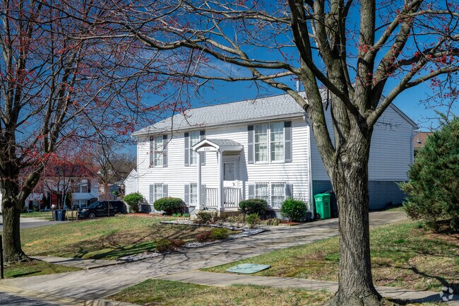 A stately white home with a spacious yard is a common sight in Coral Hills.