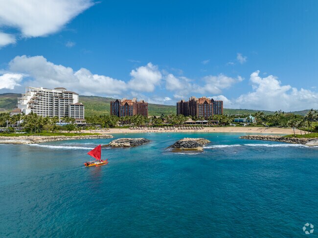 Colorful canoes sail by the lagoons at Ko'olina nearby.