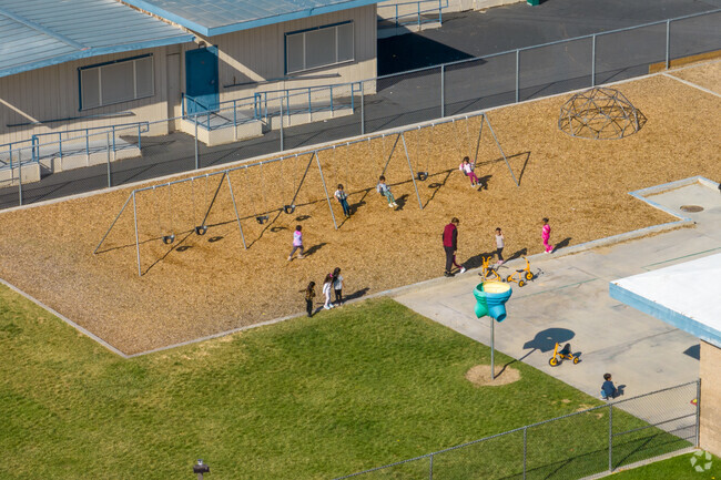 Liberty Elementary where children are enjoying recess at the swings.