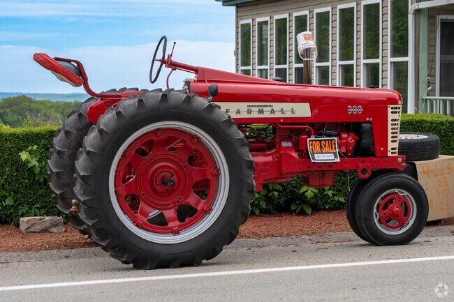 A restored Farmall tractor sits for sale along the National Road in Scenery Hill.