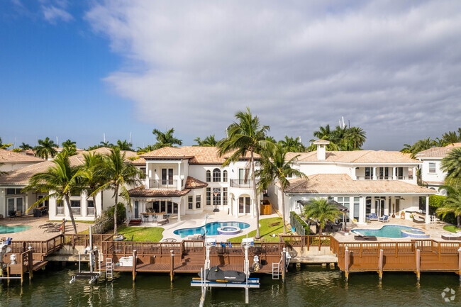 Large waterfront homes with pools and boat docks line Hollywood Beach.