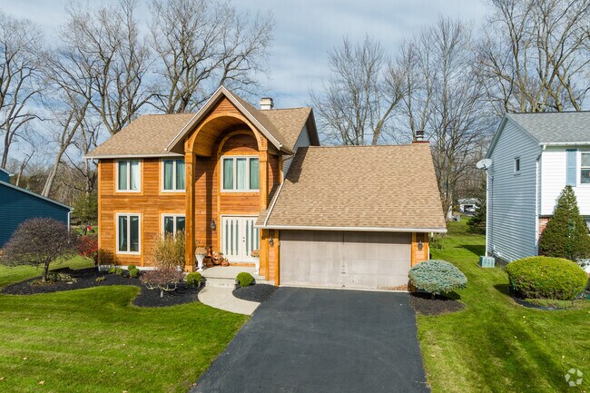 This farm style home in Getzville impresses with its two story entry arch.