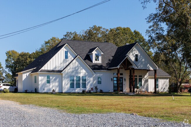 Large farmhouse style home with gabled roofs in Frierson.