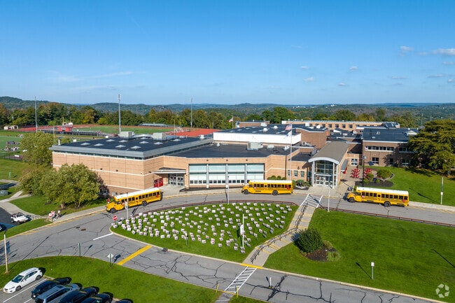 Buses drop students off from the surrounding subdivisions at Somers High School.