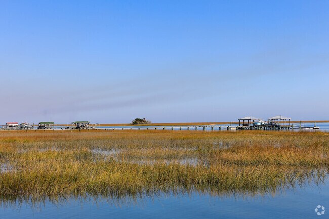 Private docks in Awendaw sit among the tall grass of the sound.
