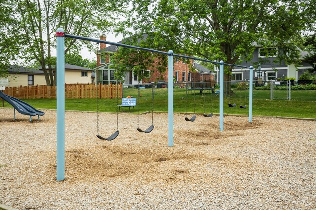 The school grounds offer a set of swing set on their playground.
