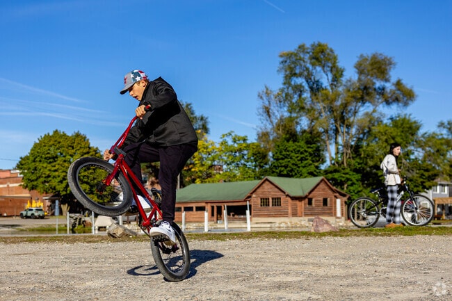 Michigan Center kids meet to ride bikes and practice tricks at Center Lake's parking lot.