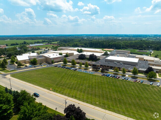 Badger High School buildings and sports fields surrounded by rural Lake Geneva landscape.