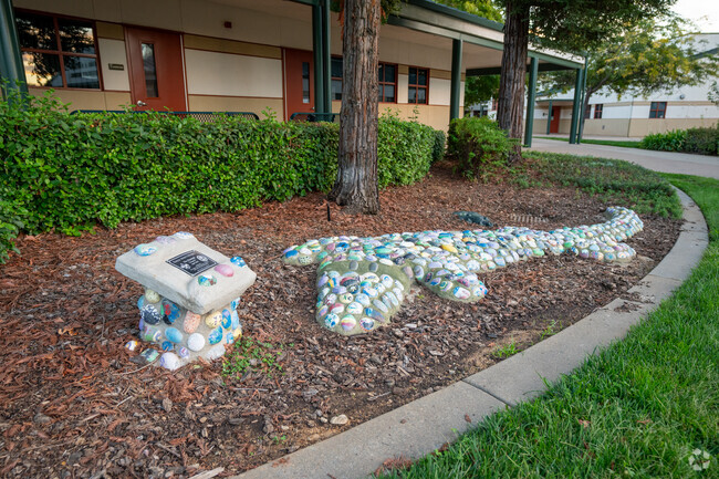 A gator rock sculpture in front of Sandra J. Gallardo Elementary School