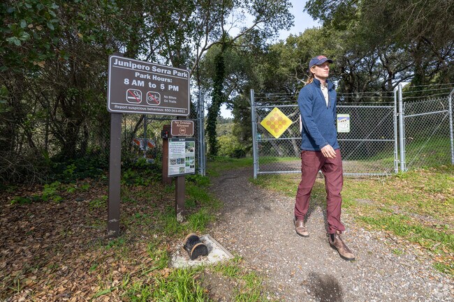 A visitor exits the trailhead at Junipero Serra County Park after an afternoon hike.