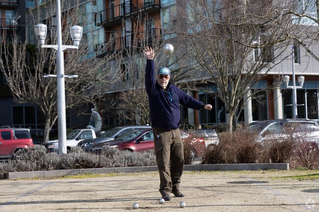 A South Waterfront resident practices Pétanque in Elizabeth Caruthers Park.