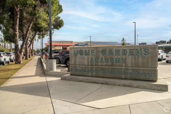 The signage at the entrance of Home Gardens Academy proudly displays its name.