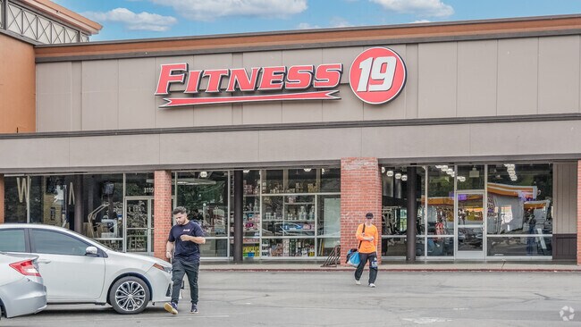 People cool down outside Fitness 19 after an invigorating workout in Fairway Park.