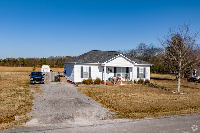 A smaller white home with a front porch in Ready Crossing.