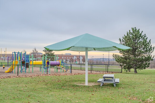 Students of South Fayette Elementary School have a large umbrella and a picnic bench to sit.
