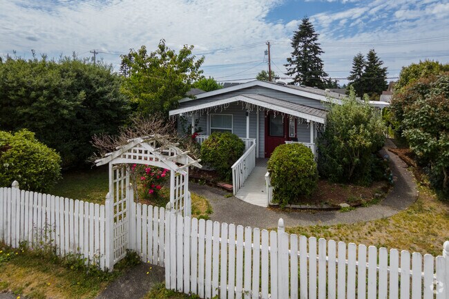 Craftman cottage with a white picket fence in the Riverside neighborhood.