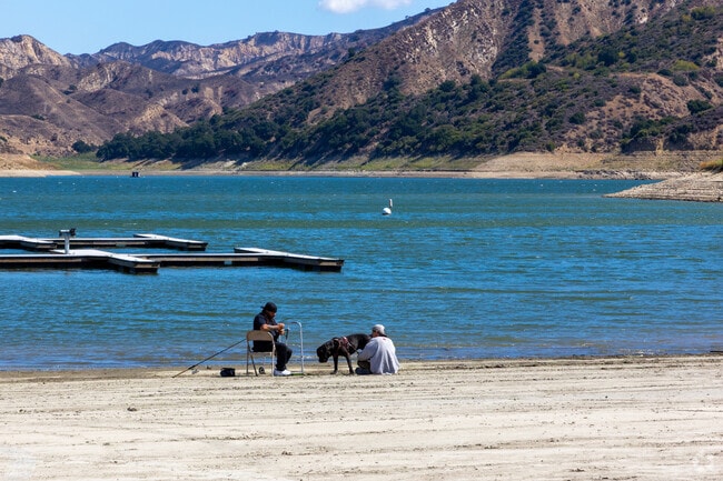 Locals fish in the shadow of mountains on Lake Piru.