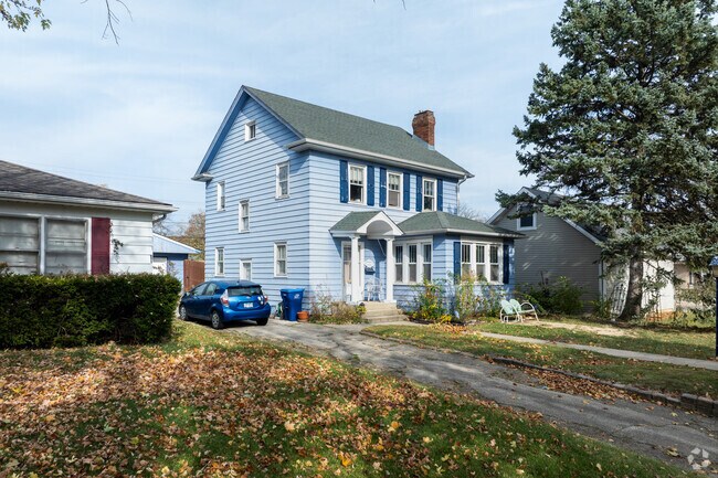 This blue traditional home stands tall among the homes in Marquette Highlands.
