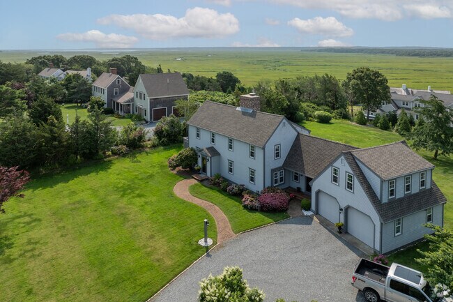 Lush green lawns surround the homes of West Barnstable.