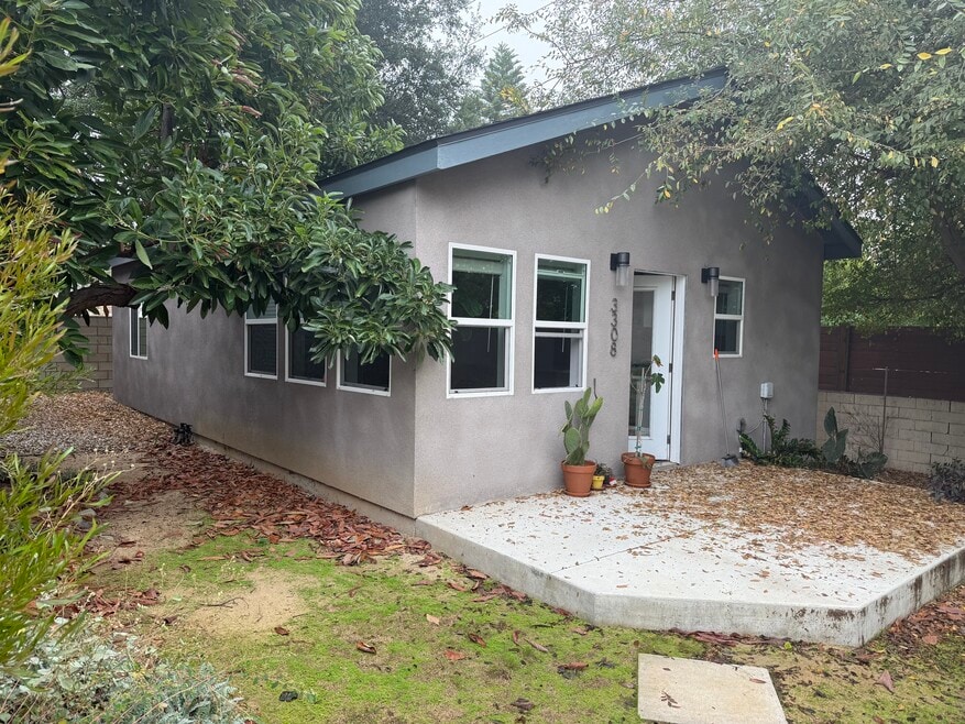 Front of house. Trees have been clipped.