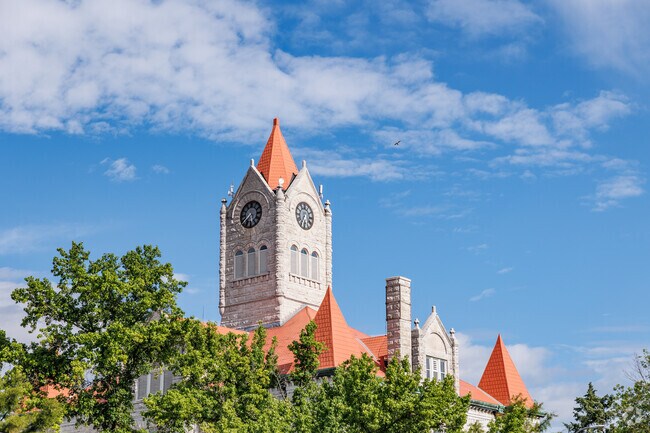 The distinctive Vernon County Courthouse juts above the trees in downtown Nevada.