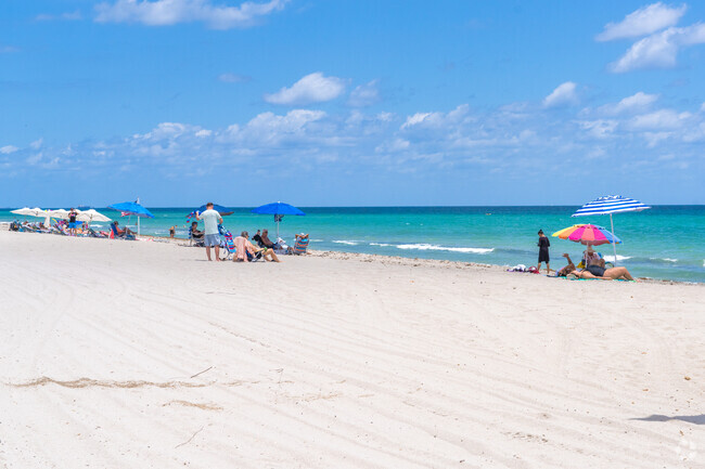 The nearby beach is a quick escape from Emerald Hills, where golden sands meet calm waves.