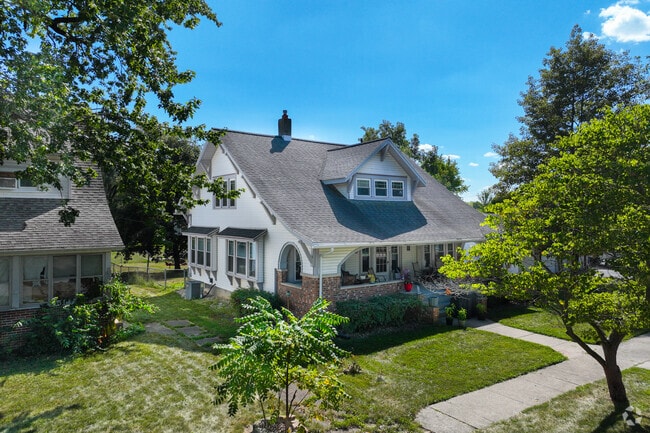 A sidewalk runs in front of bungalows in Ossian.