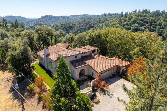 Many homes are surrounded by lush landscape in the Sierra Nevada foothills.