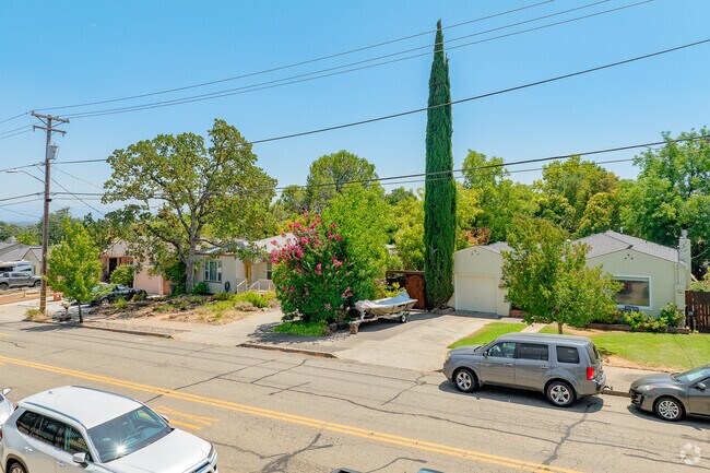 Greenwood homes are commonly landscaped with green lawns and shrubbery.