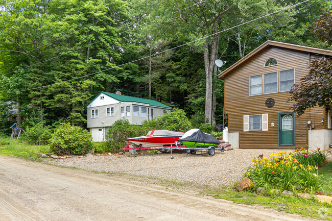 A row of cabins and homes with nearby lake access in the Gilmanton, NH neighborhood.