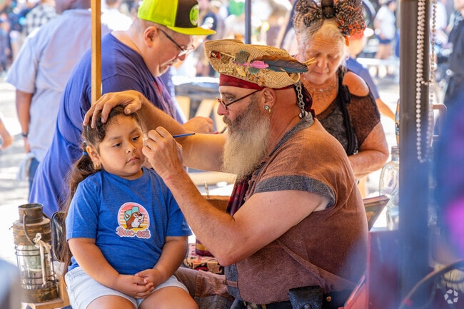 Children at Magnolia's Texas Renaissance Festival eagerly await their turn for face paint.