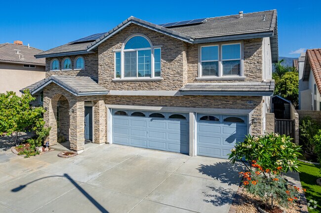 This large Bellgrove home with brickwork has solar panels and a three-car garage.