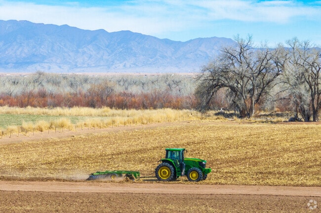 A farmer plows his field near Rio Communities.