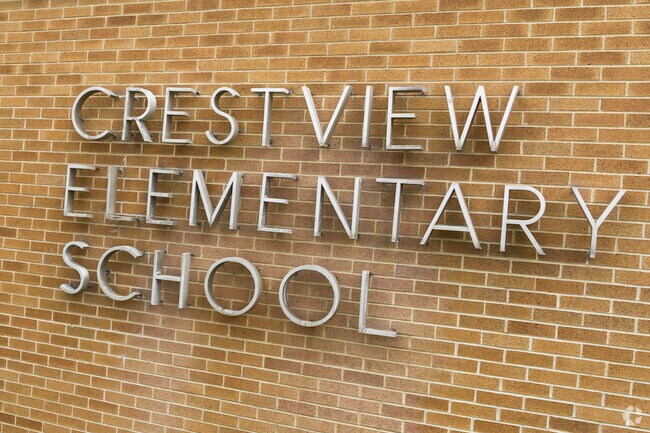 Metal letters spell out Crestview Elementary School against a brick wall.