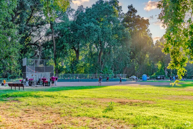 Sun sets over baseball diamond as game ensues at Bidwell Park.