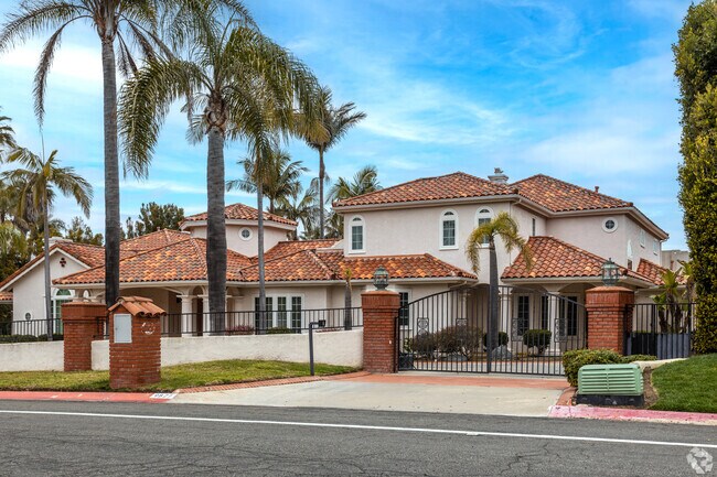 A Mediterranean-style home with a red tile roof in La Jolla Farms.