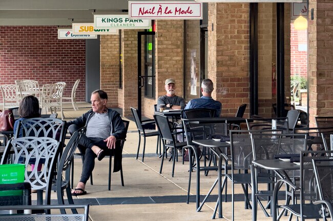 Outdoor seating at Kings Park Shopping Center fosters community in Kings Park.