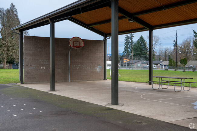 Covered basketball courts sit next to the playground behind Hathaway Elementary School.